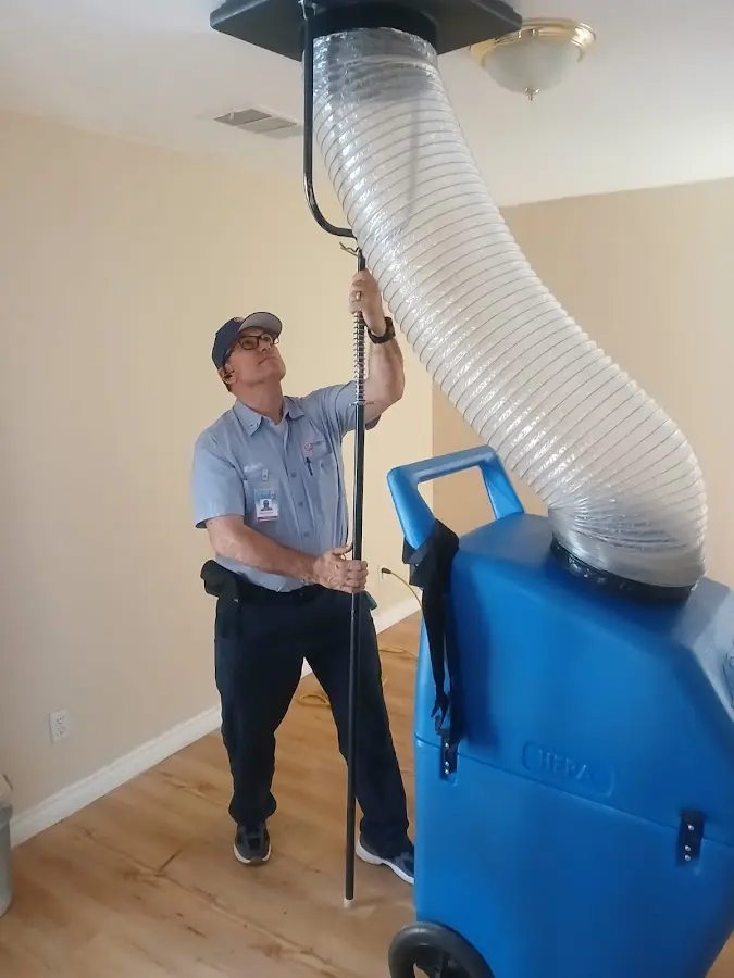 Furnace Tune-Up technician using HEPA equipment in Apopka