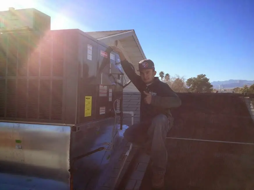 HVAC technician performing HVAC Inspection on a rooftop unit in Apopka